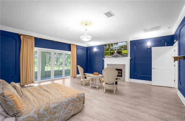 9093 E Pinehurst Ct, Inverness, FL 34450 - bedroom featuring crown molding, access to outside, a premium fireplace, and wood finished floors