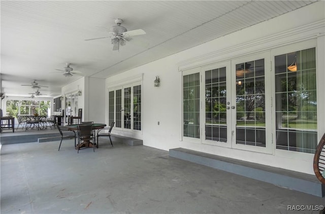 9093 E Pinehurst Ct, Inverness, FL 34450 - view of patio / terrace featuring french doors, a ceiling fan, and outdoor dining space