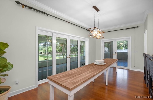 9093 E Pinehurst Ct, Inverness, FL 34450 - dining area with french doors, dark wood-style flooring, crown molding, and a chandelier