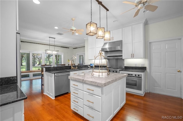 9093 E Pinehurst Ct, Inverness, FL 34450 - kitchen with stainless steel appliances, ceiling fan, extractor fan, ornamental molding, and a peninsula