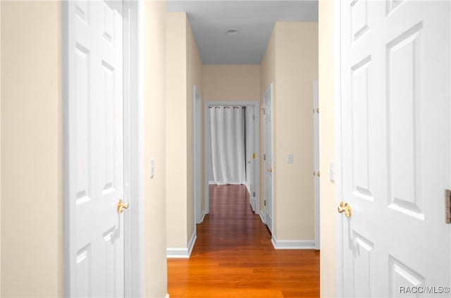 9093 E Pinehurst Ct, Inverness, FL 34450 - hallway featuring light wood-type flooring and baseboards
