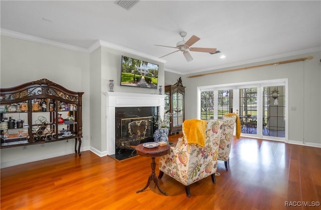 9093 E Pinehurst Ct, Inverness, FL 34450 - living area featuring ceiling fan, wood finished floors, ornamental molding, a high end fireplace, and recessed lighting