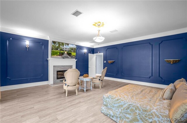 9093 E Pinehurst Ct, Inverness, FL 34450 - bedroom with a premium fireplace, ornamental molding, and light wood-style flooring