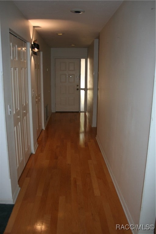 hallway with wood-type flooring