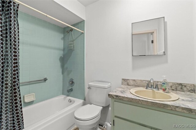 813 Constitution Blvd, Inverness, FL 34453 - bathroom featuring toilet, shower / bathtub combination with curtain, and vanity