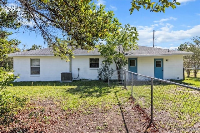 813 Constitution Blvd, Inverness, FL 34453 - back of property featuring a yard, concrete block siding, central AC, and fence