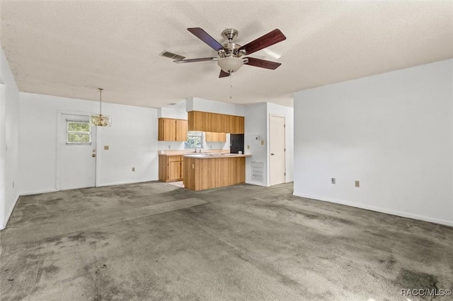 813 Constitution Blvd, Inverness, FL 34453 - unfurnished living room featuring visible vents, baseboards, ceiling fan, a textured ceiling, and light colored carpet
