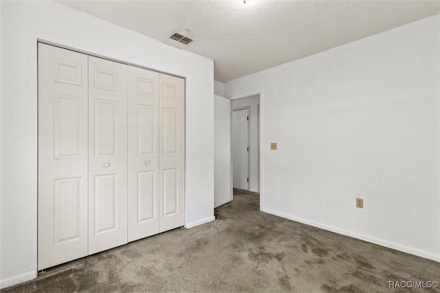 813 Constitution Blvd, Inverness, FL 34453 - unfurnished bedroom with a closet, baseboards, carpet flooring, a textured ceiling, and visible vents