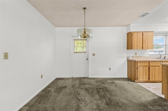 813 Constitution Blvd, Inverness, FL 34453 - unfurnished dining area with dark colored carpet, a notable chandelier, visible vents, and a sink