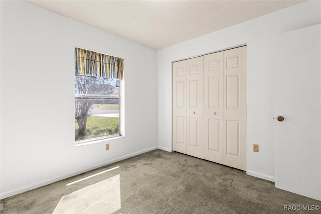 813 Constitution Blvd, Inverness, FL 34453 - unfurnished bedroom with a closet, baseboards, and carpet flooring