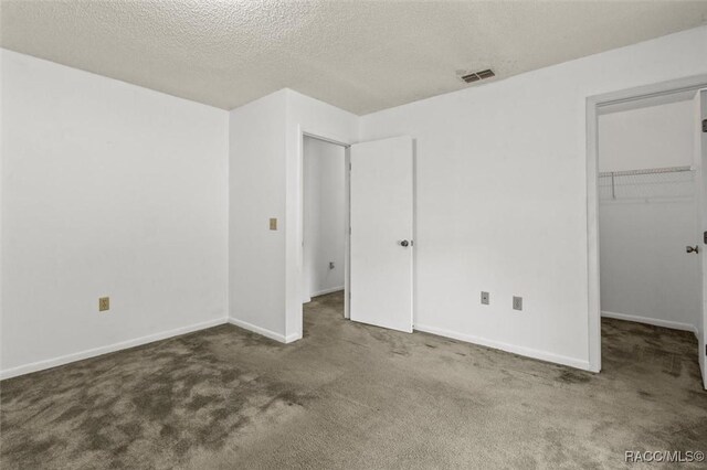 813 Constitution Blvd, Inverness, FL 34453 - unfurnished bedroom featuring a walk in closet, carpet, visible vents, and baseboards