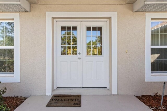 5886 W Pawnee Dr, Beverly Hills, FL 34465 - property entrance featuring stucco siding