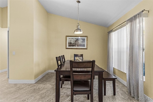 dining room featuring lofted ceiling