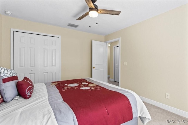 carpeted bedroom with a closet and ceiling fan