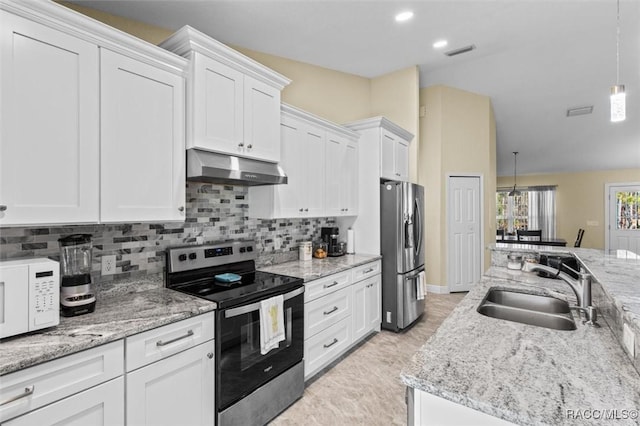 kitchen featuring appliances with stainless steel finishes, sink, white cabinetry, decorative light fixtures, and decorative backsplash