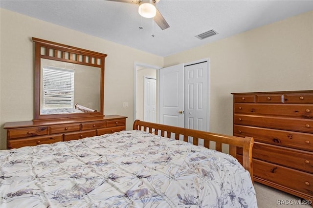 bedroom with a closet, ceiling fan, and light colored carpet