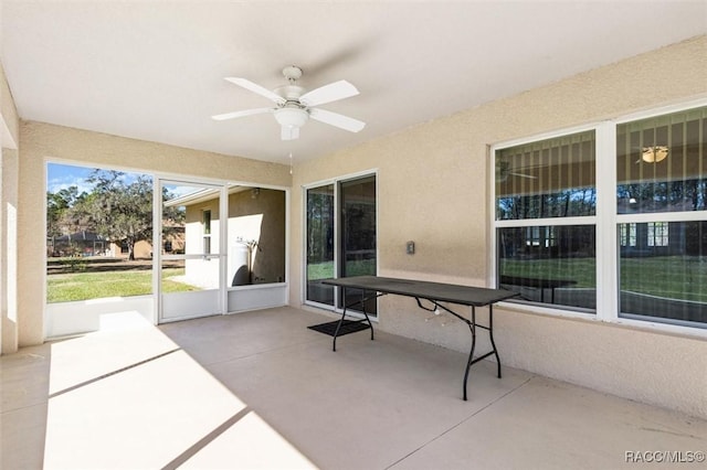 sunroom featuring ceiling fan