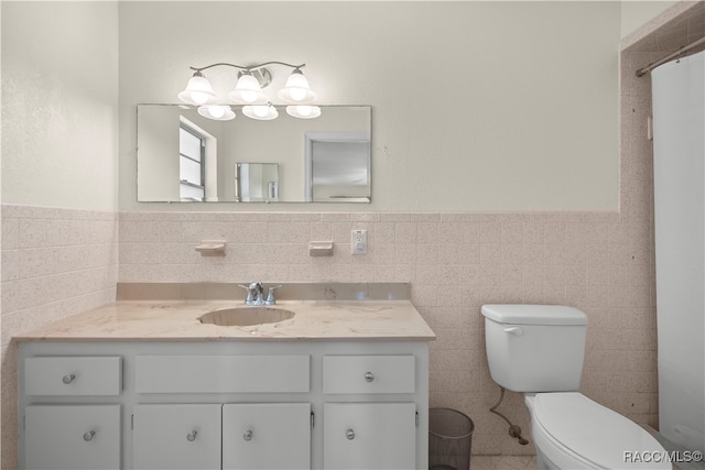 bathroom featuring vanity, toilet, and tile walls