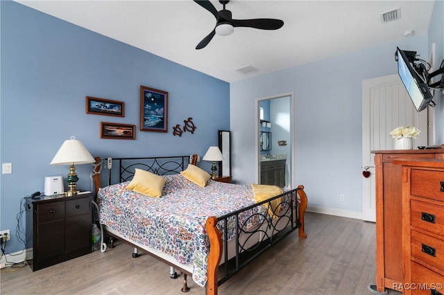 bedroom featuring ensuite bathroom, ceiling fan, and wood-type flooring