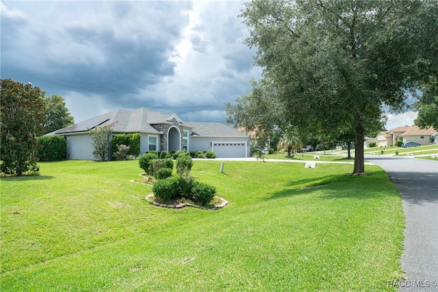 ranch-style house with a front yard and a garage