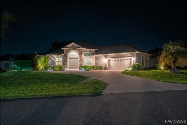 view of front facade featuring a lawn and a garage