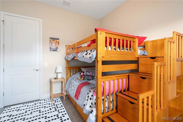 bedroom with dark hardwood / wood-style floors