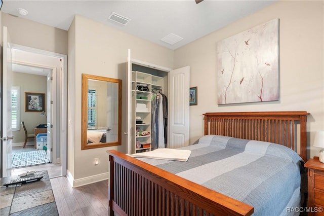 bedroom with a closet and dark wood-type flooring