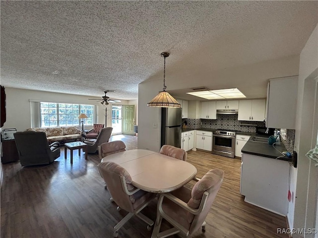 dining room with ceiling fan, dark hardwood / wood-style floors, and sink