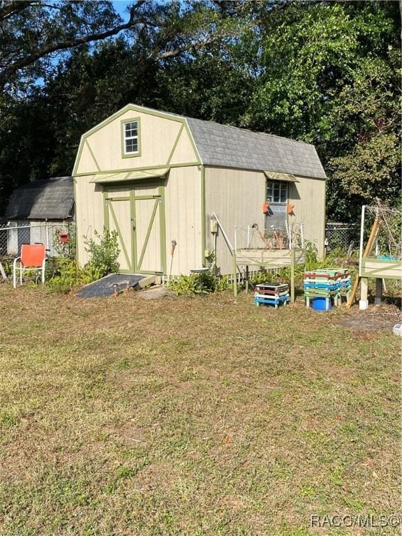 view of outdoor structure featuring a lawn