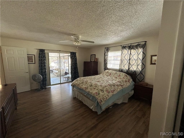 bedroom with ceiling fan, a textured ceiling, access to outside, and dark wood-type flooring