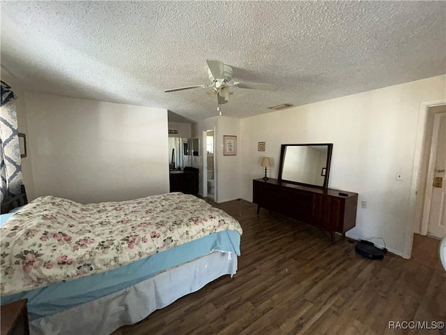 bedroom with ceiling fan, dark hardwood / wood-style floors, and a textured ceiling