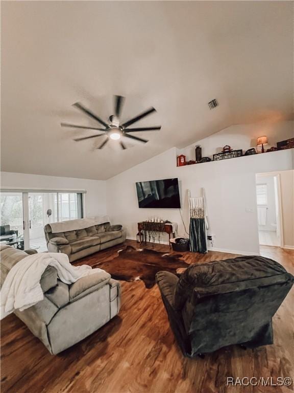 living room featuring visible vents, a ceiling fan, wood finished floors, and vaulted ceiling