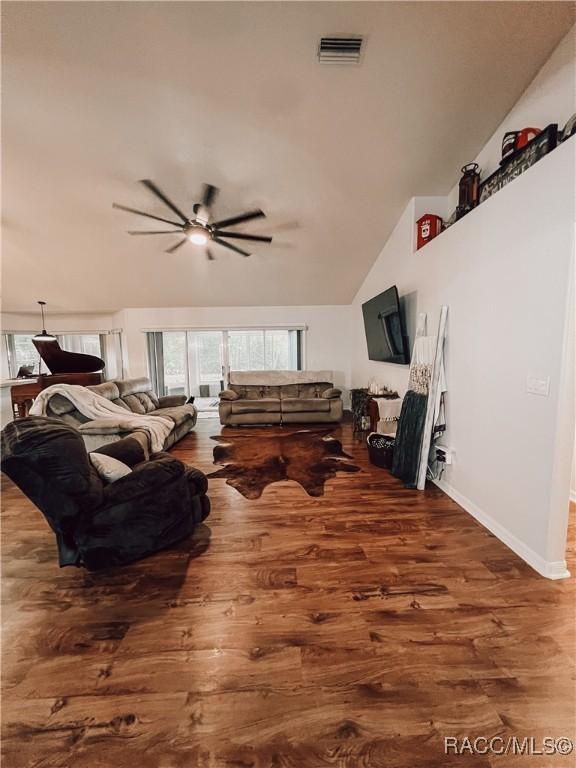 living area with ceiling fan, visible vents, plenty of natural light, and wood finished floors