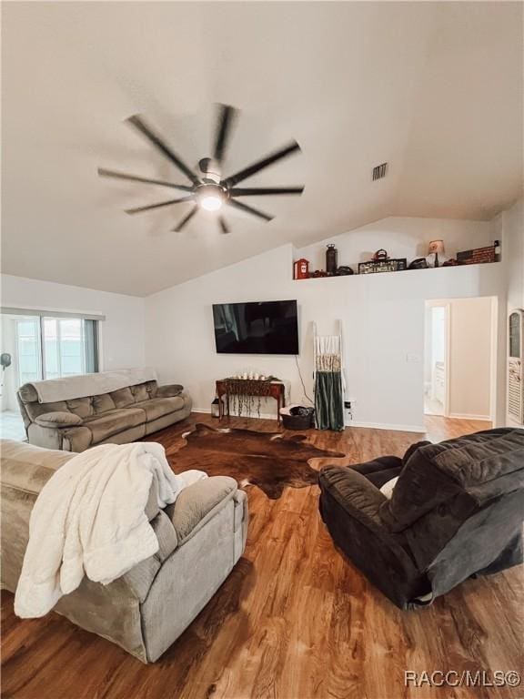 living room with visible vents, a ceiling fan, lofted ceiling, and wood finished floors