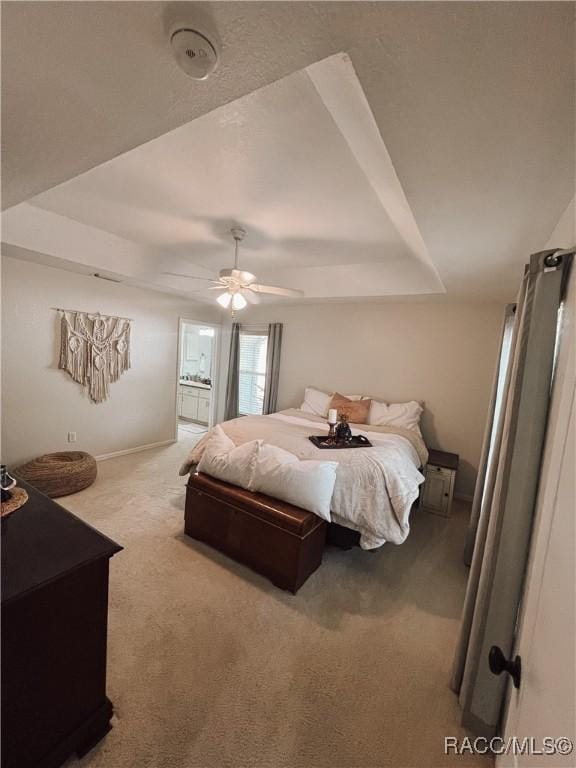 bedroom featuring carpet flooring, ceiling fan, and a tray ceiling