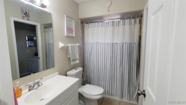 bathroom with tile patterned floors, a shower with curtain, vanity, and toilet