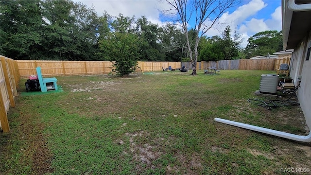 view of yard featuring central air condition unit