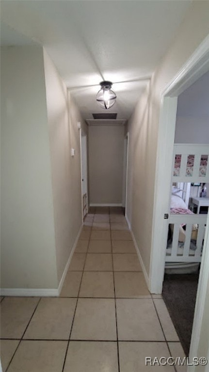 corridor featuring light tile patterned flooring