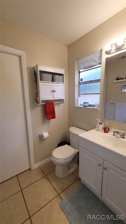 bathroom with tile patterned flooring, vanity, and toilet