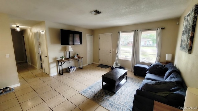 tiled living room with a textured ceiling