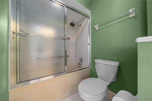 full bathroom featuring toilet, tile patterned flooring, and enclosed tub / shower combo