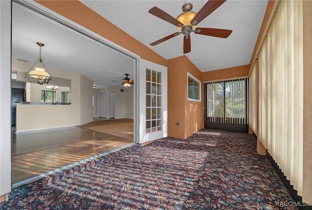 empty room with vaulted ceiling and carpet