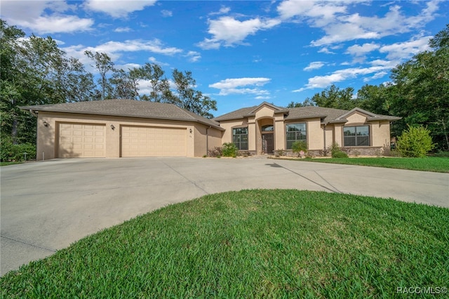 view of front of house with a garage and a front lawn