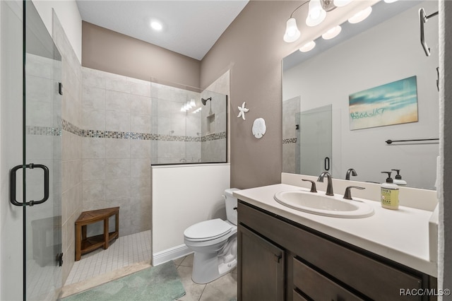 bathroom with tile patterned flooring, vanity, toilet, and a shower with door