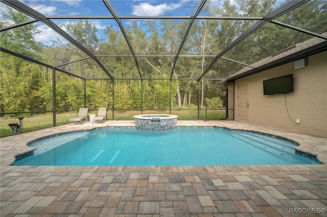 view of swimming pool featuring an in ground hot tub, glass enclosure, and a patio area