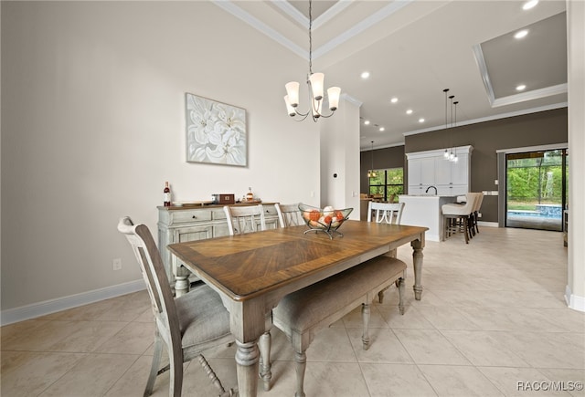 dining room with light tile patterned floors, a wealth of natural light, ornamental molding, and a notable chandelier