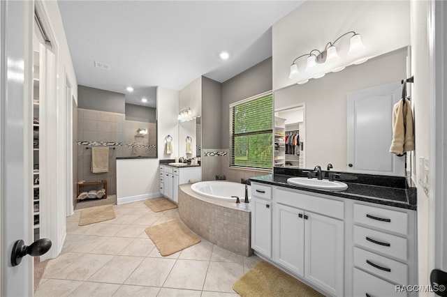 bathroom with tile patterned floors, vanity, and independent shower and bath