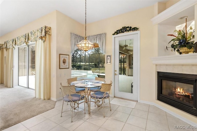 carpeted dining space featuring a high end fireplace