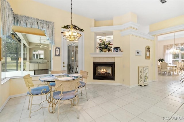 tiled dining space featuring ceiling fan