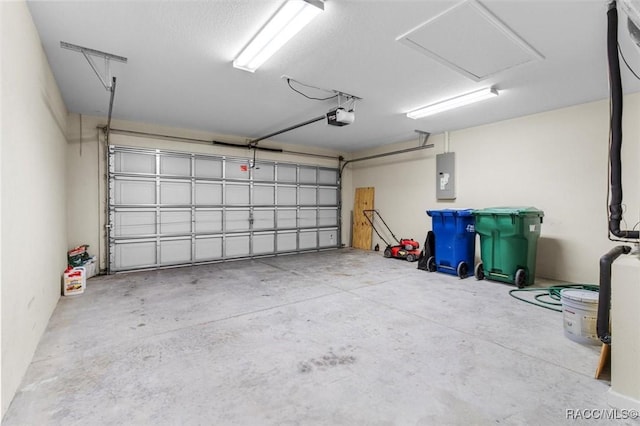 garage with a garage door opener and electric panel